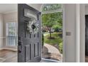 View from the front door of landscaped yard, trees, walkway, and neighborhood street at 115 Township Ct, Woodstock, GA 30189
