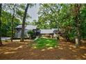 Charming home nestled among mature trees featuring a manicured front lawn and a welcoming entrance at 1510 Chevron Dr, Sandy Springs, GA 30350