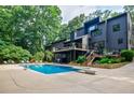 Stunning backyard oasis featuring a pool, diving board, deck, and lounge chairs for relaxing and entertaining at 1510 Chevron Dr, Sandy Springs, GA 30350