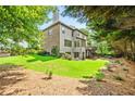 Expansive backyard featuring a well-maintained lawn and mature trees offers a private outdoor space at 2953 Kings Walk Ave, Marietta, GA 30062