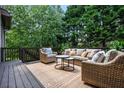 Cozy outdoor deck featuring comfortable seating, patterned rug and natural surroundings at 2953 Kings Walk Ave, Marietta, GA 30062