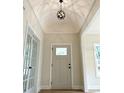 Inviting foyer with a stylish light fixture, neutral walls, and a view of the front door at 387 Hillside Sw Dr, Atlanta, GA 30310