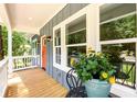 Charming porch view, featuring outdoor seating, bright windows, and a welcoming atmosphere with a potted plant at 387 Hillside Sw Dr, Atlanta, GA 30310