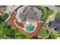 Aerial view of backyard featuring in-ground pool, hot tub and patio area with outdoor seating at 5009 Kingsley Manor Ct, Marietta, GA 30066
