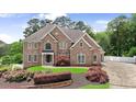 Beautiful brick home featuring manicured landscaping, a well-maintained lawn, and an inviting entrance at 5009 Kingsley Manor Ct, Marietta, GA 30066