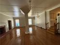 Spacious living room with hardwood floors, chandeliers, and staircase at 2807 Mcclave Dr, Doraville, GA 30340