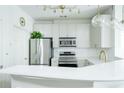 Bright kitchen featuring stainless steel appliances, pendant lighting, and white cabinets at 400 17Th Street Nw # 2313, Atlanta, GA 30363