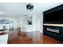 Open floor plan with modern fireplace, breakfast bar, and gleaming hardwood floors at 400 17Th Street Nw # 2313, Atlanta, GA 30363