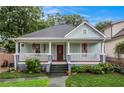 Bungalow-style home with a welcoming front porch, lush landscaping, and a well-manicured lawn at 1292 Eubanks Ave, East Point, GA 30344