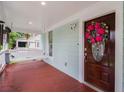 Charming porch with a swing, stylish front door with a wreath, and well-maintained flooring at 1292 Eubanks Ave, East Point, GA 30344