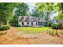 Expansive backyard with a well-maintained lawn, mature trees, and a deck, perfect for outdoor living at 2007 Mount Vernon Pl, Dunwoody, GA 30338
