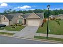 Well-kept one-story home features a manicured lawn and two-car garage at 2292 Knob Creek Rd, Snellville, GA 30078