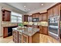 Gourmet kitchen with a large island, granite countertops, and stainless steel appliances at 525 Water Shadow Ln, Alpharetta, GA 30022