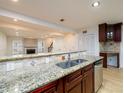 Modern kitchen features stainless steel appliances and granite countertops overlooking the living area at 7500 Roswell Rd # 18, Sandy Springs, GA 30350