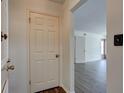 Neutral hallway leading to rooms with hardwood flooring and a white door at 6851 Roswell Rd # G20, Sandy Springs, GA 30328