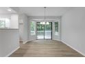 Dining area with hardwood floors, bay window and sliding glass door to outdoor deck at 740 Stoneside Ct, Stone Mountain, GA 30083