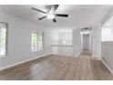 Bright open-concept living area with hardwood floors, ceiling fan, and large windows at 740 Stoneside Ct, Stone Mountain, GA 30083