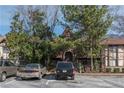Exterior shot of a complex with unique architecture and ample parking space at 1213 Camelot Dr, Atlanta, GA 30349