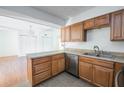 Kitchen featuring wood cabinets, stainless steel appliances, and an adjacent living area at 1213 Camelot Dr, Atlanta, GA 30349