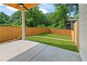 Concrete backyard patio featuring a well maintained lawn and wood fence at 1238 Memorial Se Dr # A, Atlanta, GA 30316