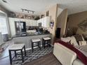 Open kitchen with white cabinets, dark countertops, and modern stainless steel appliances at 1346 Pilgrim Lake Dr, Cumming, GA 30040