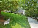 Exterior of home featuring luscious green lawn and winding driveway at 610 Lake Dr, Snellville, GA 30039
