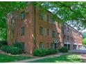 Brick building with lush green trees and lawn at 1400 Chalmette Ne Dr # 2, Atlanta, GA 30306