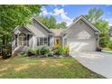 Charming single-Gathering home with a well-manicured lawn, complemented by a yellow door and attached garage at 2730 Samples Rd, Cumming, GA 30041