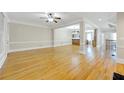 Expansive living room features hardwood floors, and open floor plan, with decorative trim at 4742 Legacy Cove Ln, Smyrna, GA 30126