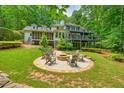Beautiful backyard with a fire pit, perfect for entertaining guests or relaxing outdoors at 627 Apache Trl, Woodstock, GA 30189