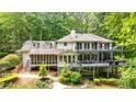 Stunning lake house with multiple decks, screened porch, and lush landscaping at 627 Apache Trl, Woodstock, GA 30189