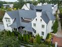 Beautiful aerial view of white townhouse and gray roofs showcasing the manicured landscaping and elegant architectural details at 201 Dovecrest Dr, Atlanta, GA 30305