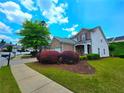 Well-maintained two-story home with a brick facade, showcasing a green lawn and colorful shrubs at 2077 Appaloosa Way Way, Conyers, GA 30012