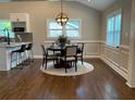 Elegant dining room with wainscoting, hardwood floors, and stylish chandelier at 2170 Beecher Sw Cir, Atlanta, GA 30311