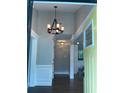 Inviting foyer featuring hardwood floors, an elegant chandelier, and a glimpse into the home's open layout at 2170 Beecher Sw Cir, Atlanta, GA 30311
