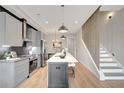 Modern kitchen boasts stainless steel appliances, gray cabinets, and a large island at 458 Connally Se St, Atlanta, GA 30312