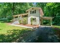 Charming home with brick exterior, shutters, manicured lawn, and inviting front entrance at 481 Meadowbrook Se Dr, Marietta, GA 30067