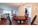 Cozy dining area with a round wooden table, seating for four, and view to the living room at 6851 Roswell Rd # G3, Atlanta, GA 30328