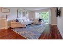 Inviting living room with a large sectional sofa, stylish rug, and a sliding glass door to the outside at 6851 Roswell Rd # G3, Atlanta, GA 30328