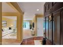 Inviting foyer leading to a sunlit living room with hardwood floors and a view of the balcony at 26303 Plantation Ne Dr # 303, Atlanta, GA 30324