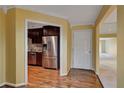 Hallway view showing stainless steel appliances and hardwood floors, connecting the kitchen to other areas of the home at 26303 Plantation Ne Dr # 303, Atlanta, GA 30324