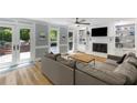 Bright living room with fireplace, built-in shelves, and french doors to outdoor patio at 2870 Livsey Woods Dr, Tucker, GA 30084