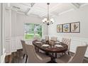 Elegant dining room with coffered ceilings, chandelier, and large window at 4967 Zoya Sw Ct, Atlanta, GA 30331