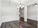 Spacious dining area with hardwood floors, coffered ceilings, and modern lighting at 4967 Zoya Sw Ct, Atlanta, GA 30331