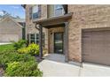 Inviting front entrance with stylish door, manicured landscaping, and covered porch at 4967 Zoya Sw Ct, Atlanta, GA 30331