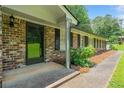 Close-up of the home's entryway showing brick facade and manicured landscaping at 2173 Tanglewood Ne Trl, Conyers, GA 30013