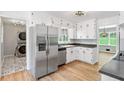 Well-equipped kitchen featuring stainless steel appliances, granite countertops, and white cabinets at 2173 Tanglewood Ne Trl, Conyers, GA 30013