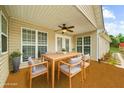 Comfortable outdoor patio with ceiling fan, dining table and chairs, ideal for entertaining at 2685 Gateview Ct, Cumming, GA 30040