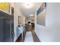 Warm and inviting hallway featuring wood floors, modern decor, and view to the living room at 3018 Patriot Square, Marietta, GA 30064