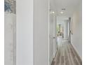 Bright hallway with neutral paint, light flooring, and a view into living area at 5451 Baybrook Cir, South Fulton, GA 30349